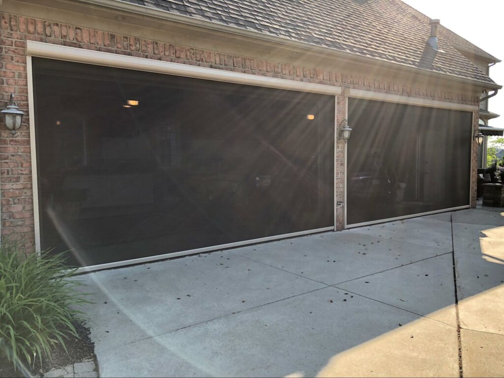 Garage with a retractable mosquito screen to keep the insects out, Tampa, Florida motorized roll down shade | Sun Protection