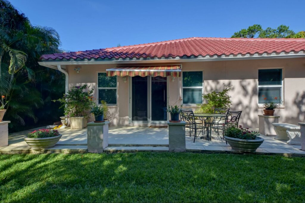 Deck with motorized awning, landscape is trimmed and pruned to protect fabric, Tampa, Florida retractable motorized awning | Sun Protection