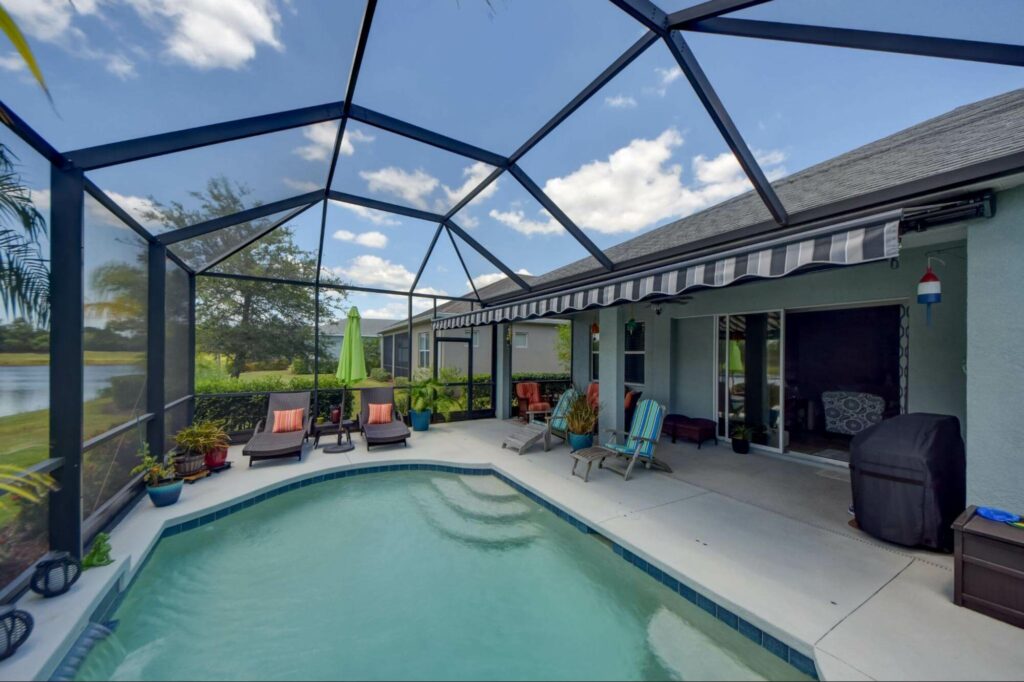 A beautiful blue striped awning complements this Orlando poolside patio. Sun Protection of Florida has many options available that add instant style to your home.