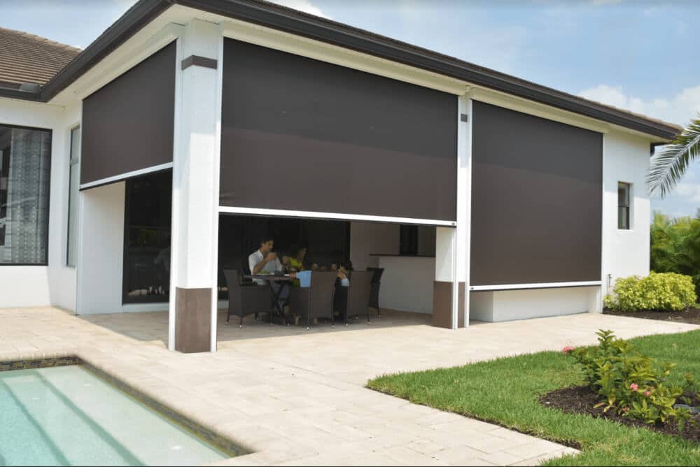 A retractable screen provides sun protection on a patio.