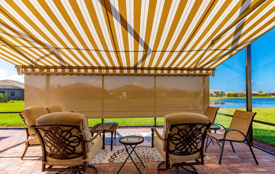 These homeowners have opted for a beautiful yellow-striped awning with an additional shade screen to provide optimum protection from the Florida elements.