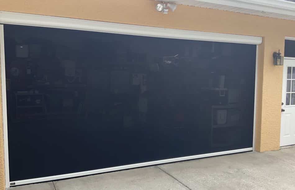 A Jacksonville home with a retractable garage door bug screen still allows the air to filter through but keeps out annoying insects and offers shade and privacy.