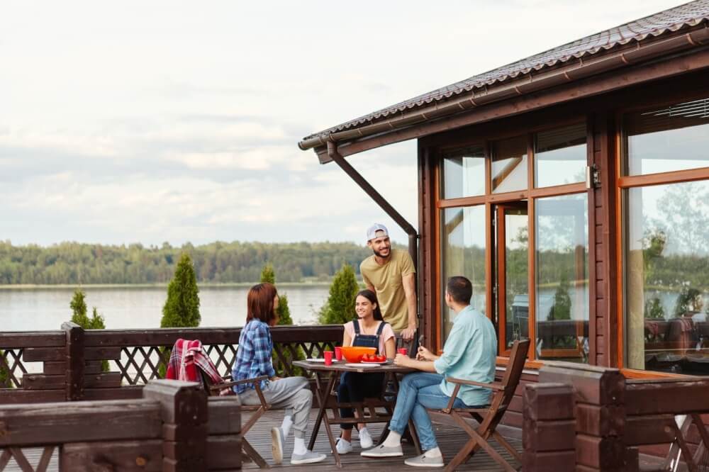 Friends enjoy dinner on their porch without pesky mosquitos chasing them indoors. A professional pest control company sprays their yard to keep bugs away.| Sun Protection