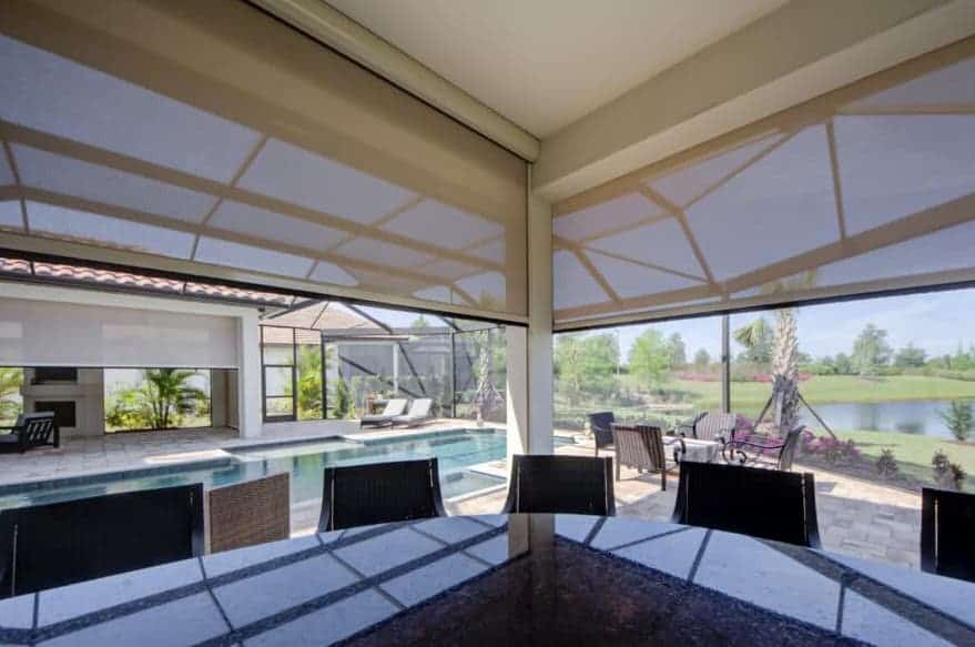 An amazing poolside bar and patio features retractable recessed solar screens to block the hot afternoon sun. Learn more about how SPF can update your lanai or balcony.