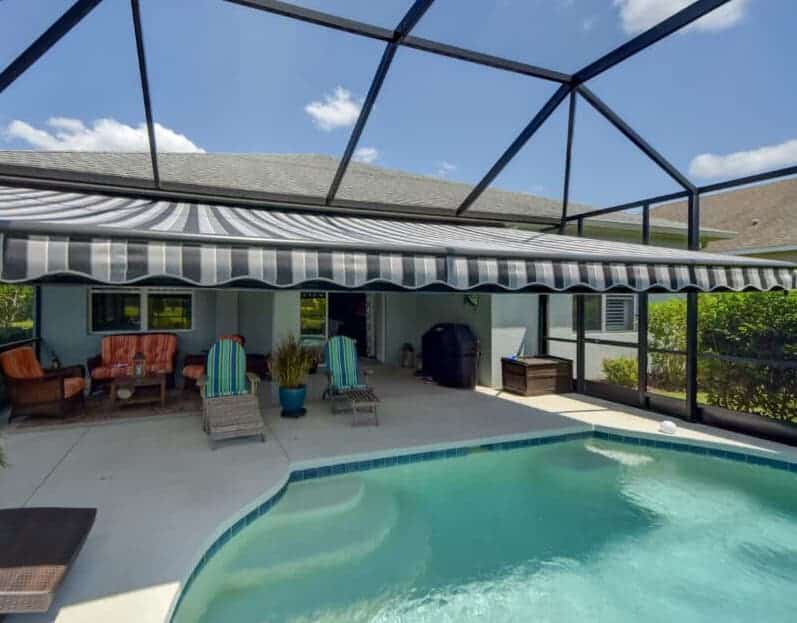 This Florida homeowner selected a gorgeous grey striped motorized patio awning to shade their seating area and part of the pool. Read more about awning options here.