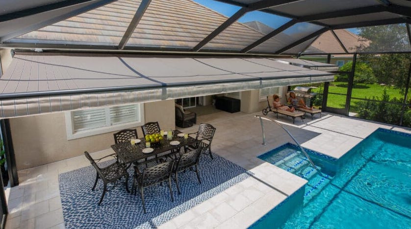 A sleek retractable motorized awning adds style and function to this Florida home. At the push of a button, these homeowners have instant protection. | Sun Protection