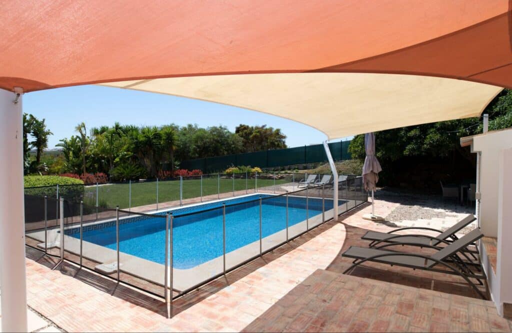 A homeowner has chosen sun shade sails as an option to provide relief from the hot Florida sun.